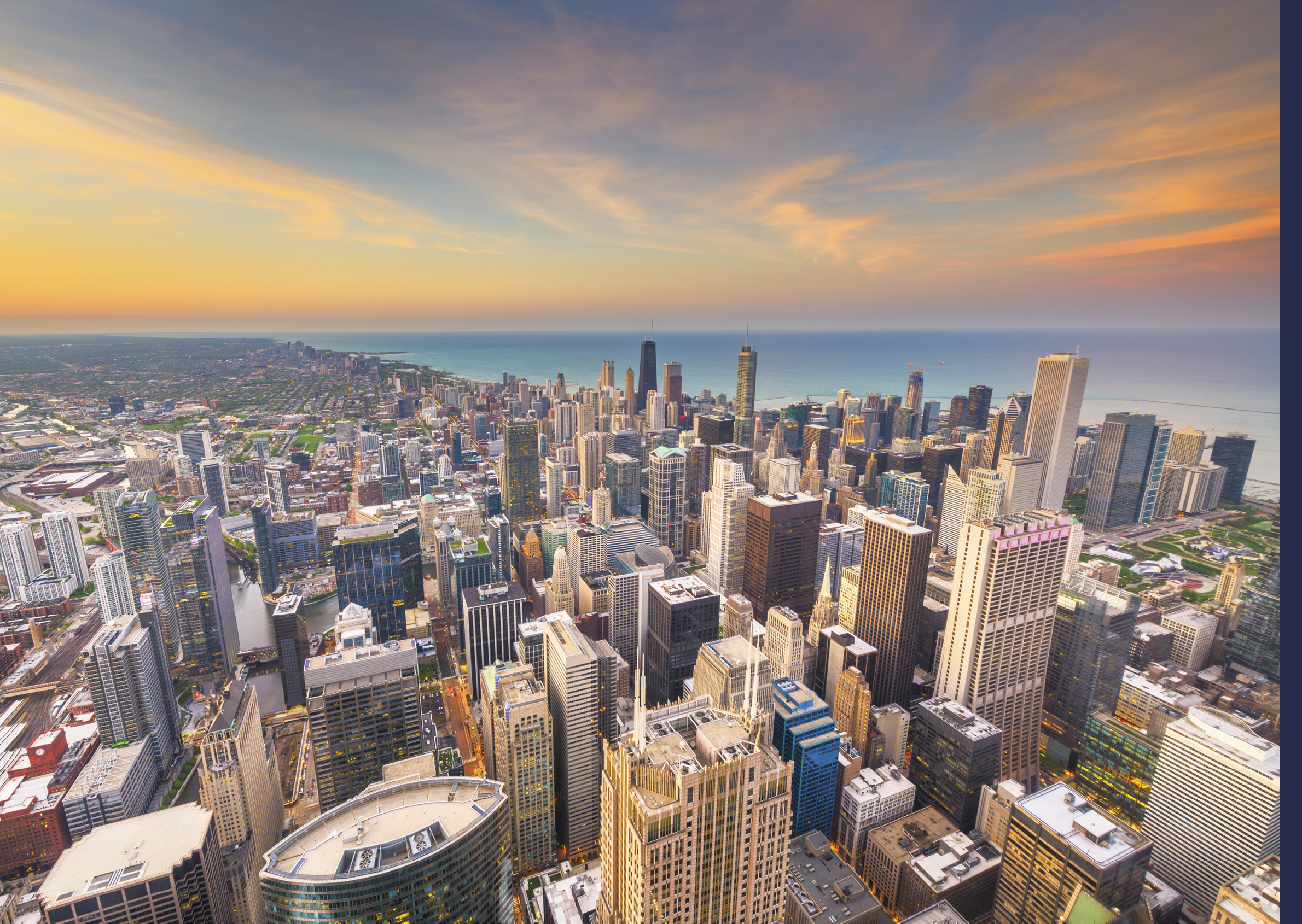 Chicago, Illinois USA aerial skyline over downtown towards Lake Michigan just after sunset.