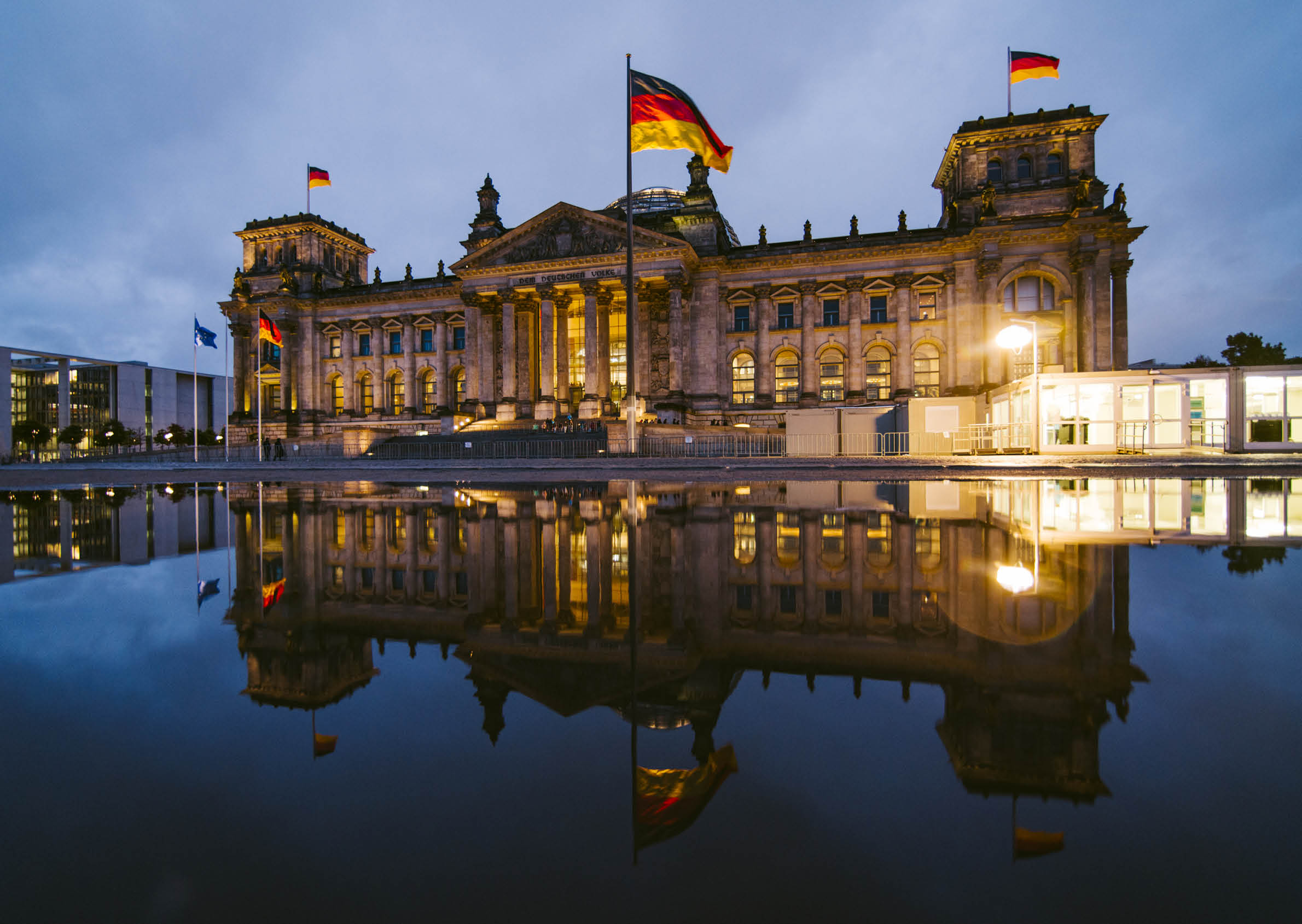 The Reichstag building in Berlin, Germany, and its reflection at night
