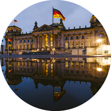 The Reichstag building in Berlin, Germany, and its reflection at night