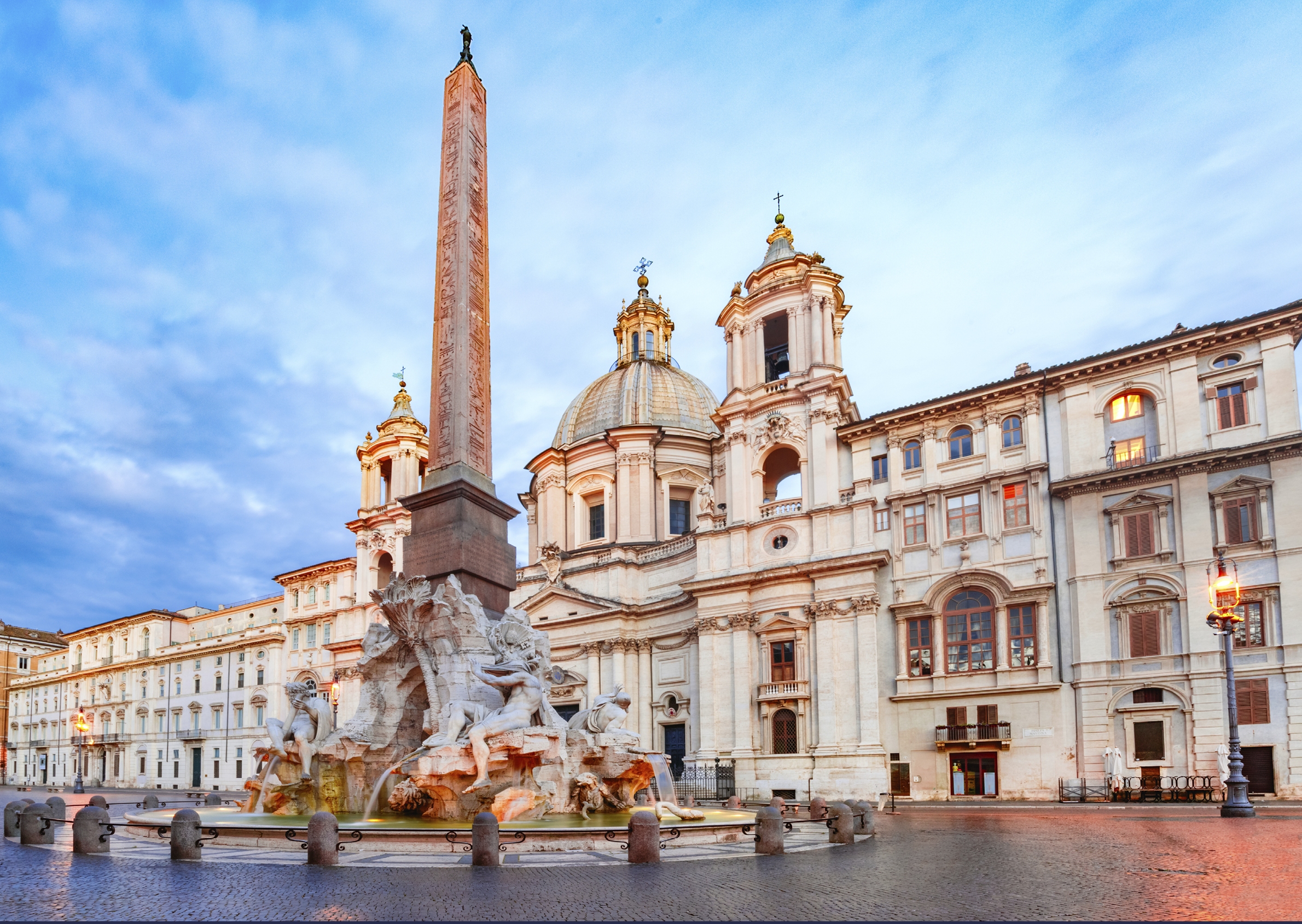 Fountain of the Four Rivers with an Egyptian obelisk and Sant Agnese Church on the famous Piazza Navona Square in the morning, Rome, Italy.