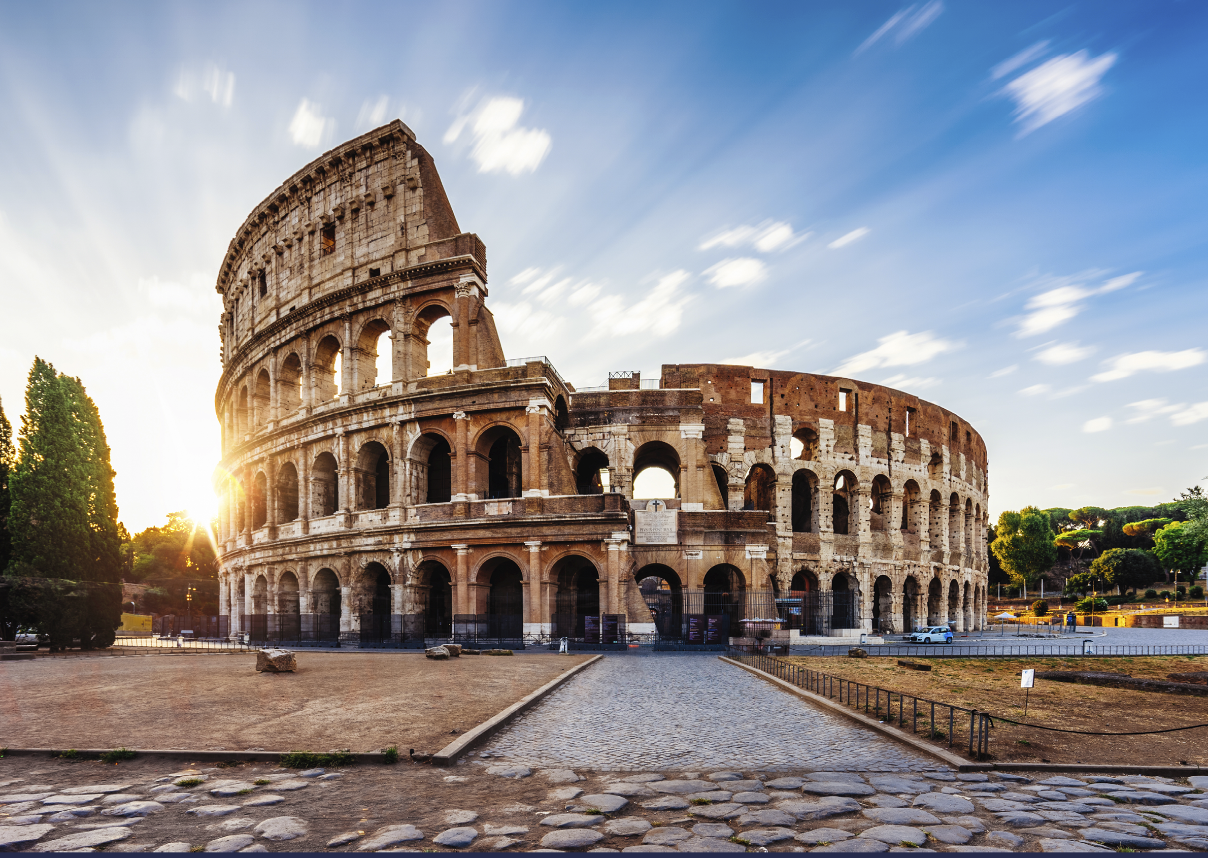 Colosseum in Rome during sunrise. Italy travel destination. Long exposure image with moving clouds.