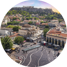 Aerial view of popular Monastiraki square with the church of Pantanassa and the city view with the Acropolis site and Parthenon on the hill on a beautiful day with fascinating sky during sunset. Popular travel destination in Europe.