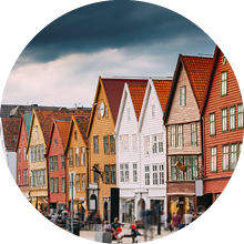 Bergen, Norway. Tourists People Visiting Historical Landmark Houses In Bryggen - Hanseatic Wharf In Bergen, Norway. UNESCO World Heritage Site. Famous Landmark. Destination Scenic