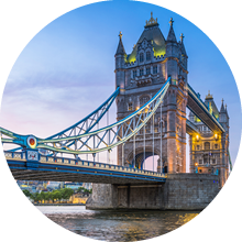Summer sunset skies above the iconic span of Tower Bridge above the slow moving waters of the River Thames in the heart of London, Britain's vibrant capital city.