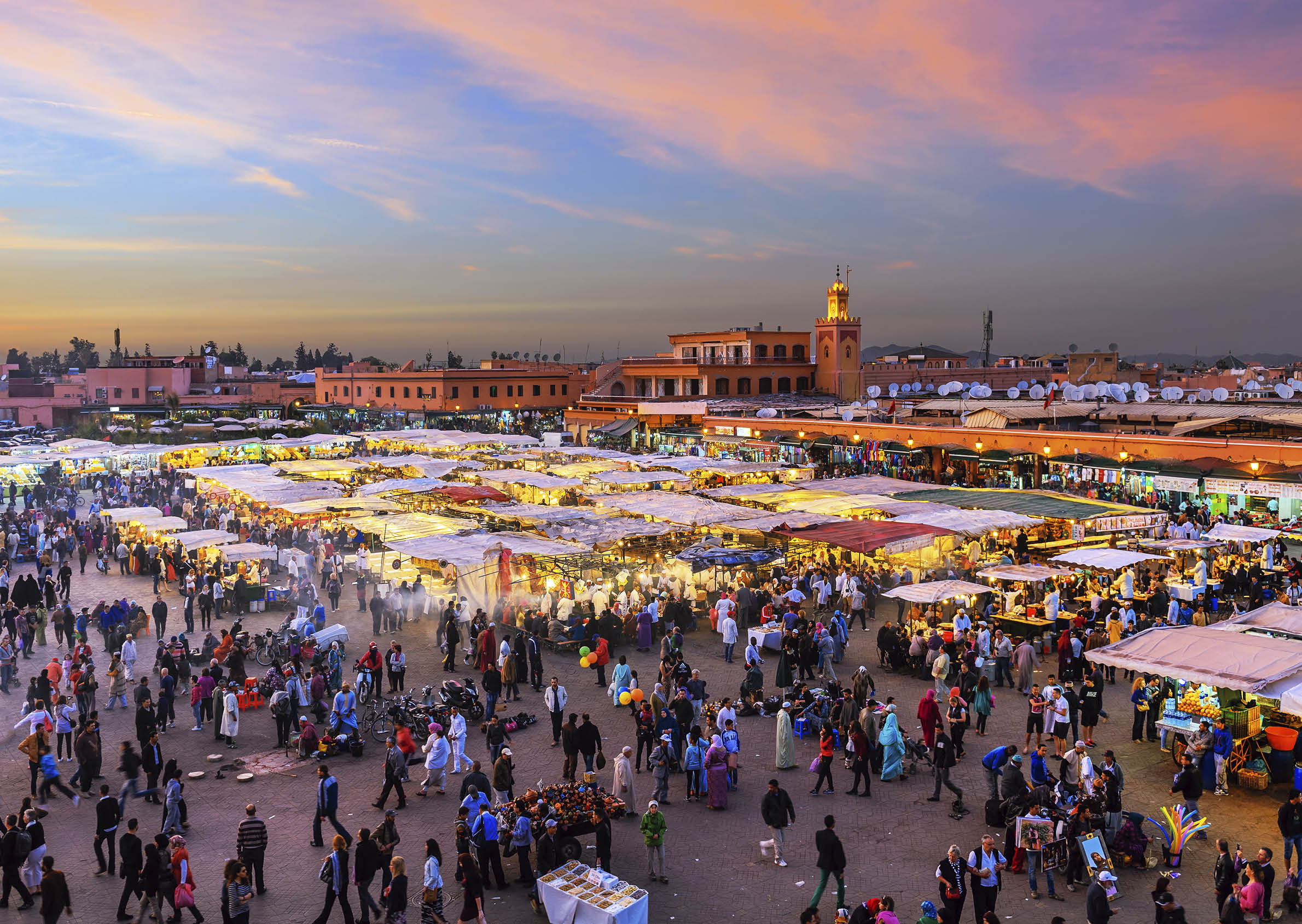 Famous Djemaa El Fna Square in early evening light, Marrakech, Morocco with the Koutoubia Mosque, Northern Africa.Nikon D3x