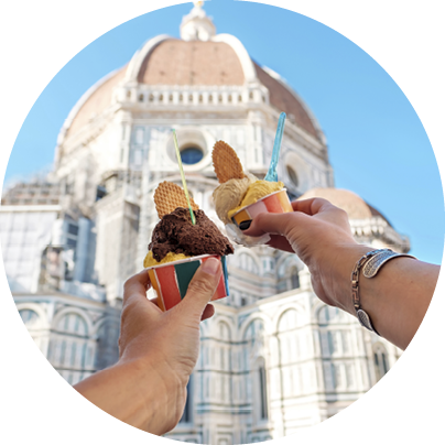 Women's hands with ice cream Gelato on the background of the city sight Cathedral of Santa Maria del Fiore in the historical center of Florence, Italy, Europe, a famous tourist place
