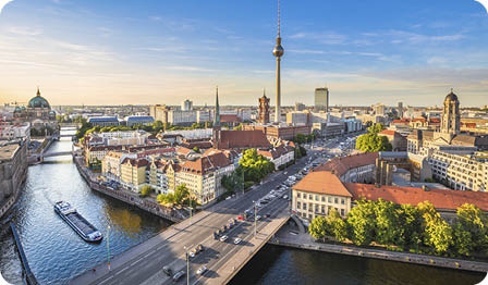 Aerial view of Berlin skyline with famous TV tower and Spree river in beautiful evening light at sunset, Germany