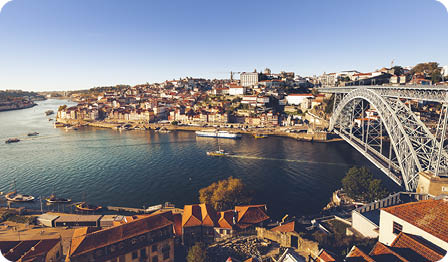 oporto city with douro river and dom luiz bridge under blue sky, portugal.