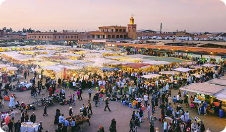 Famous Djemaa El Fna Square in early evening light, Marrakech, Morocco with the Koutoubia Mosque, Northern Africa.Nikon D3x
