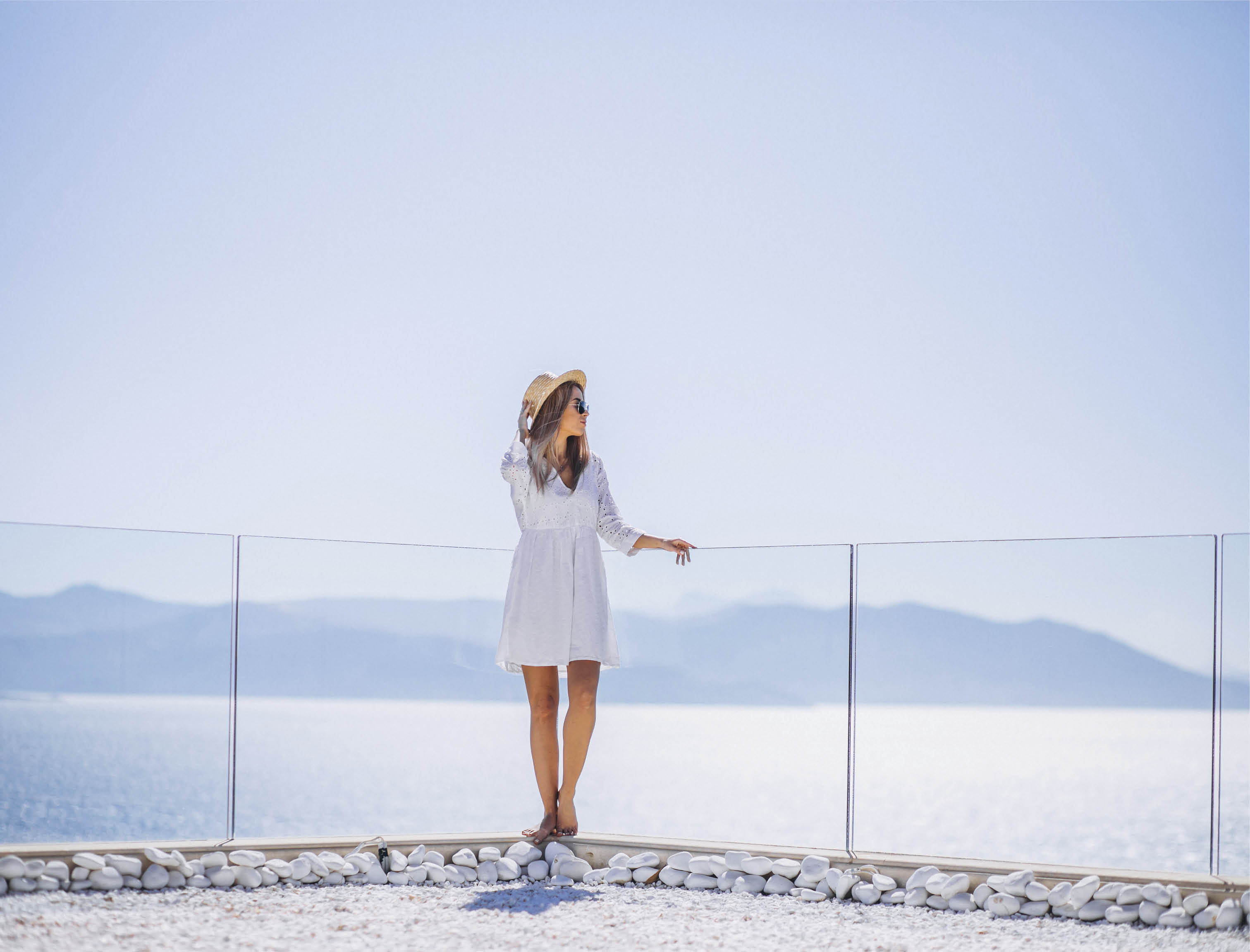 Young woman on a vacation looking at the sea