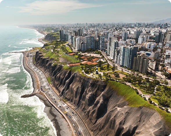 LIMA, PERU: Aerial view of Miraflores town, cliff and the Costa Verde high way